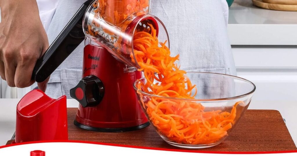 Geedel Rotary Cheese Grater: Features & Buying Guide 1 Geedel rotary cheese grater with three interchangeable blades, hand crank, and suction base for cheese shredding and vegetable slicing.